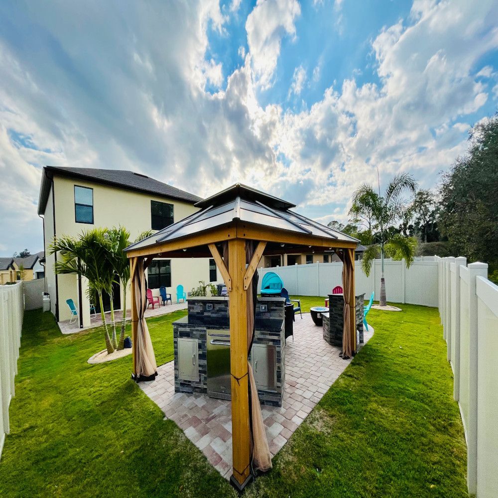 There is a gazebo in the backyard of a house.