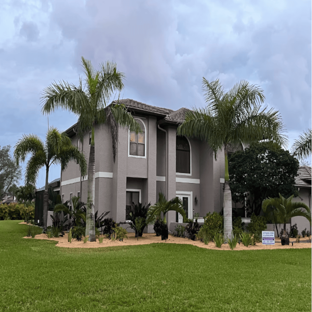 A large house with palm trees in front of it