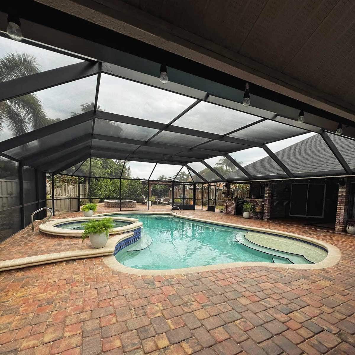A large indoor swimming pool with a clear roof