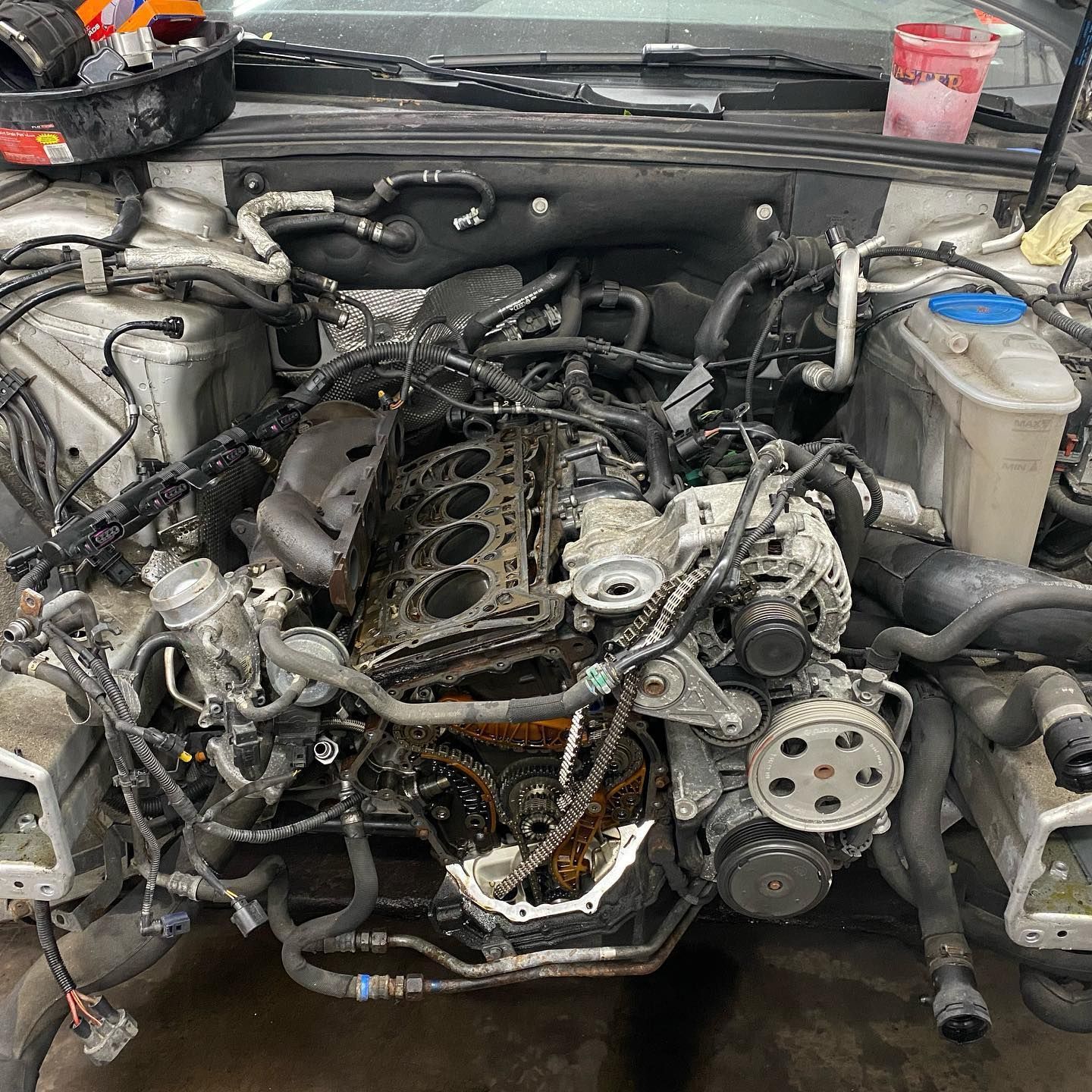 A car engine is being worked on in a garage.