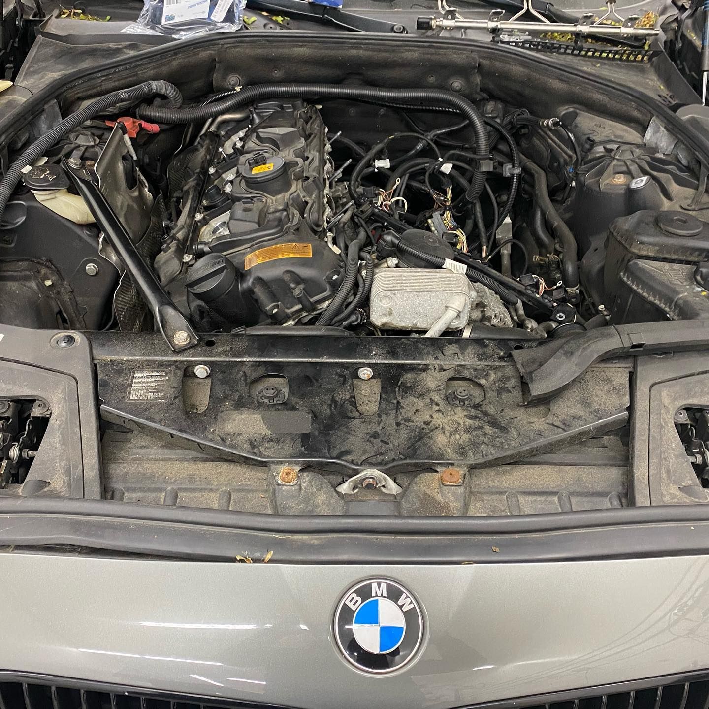 The engine of a bmw is shown with the hood open.