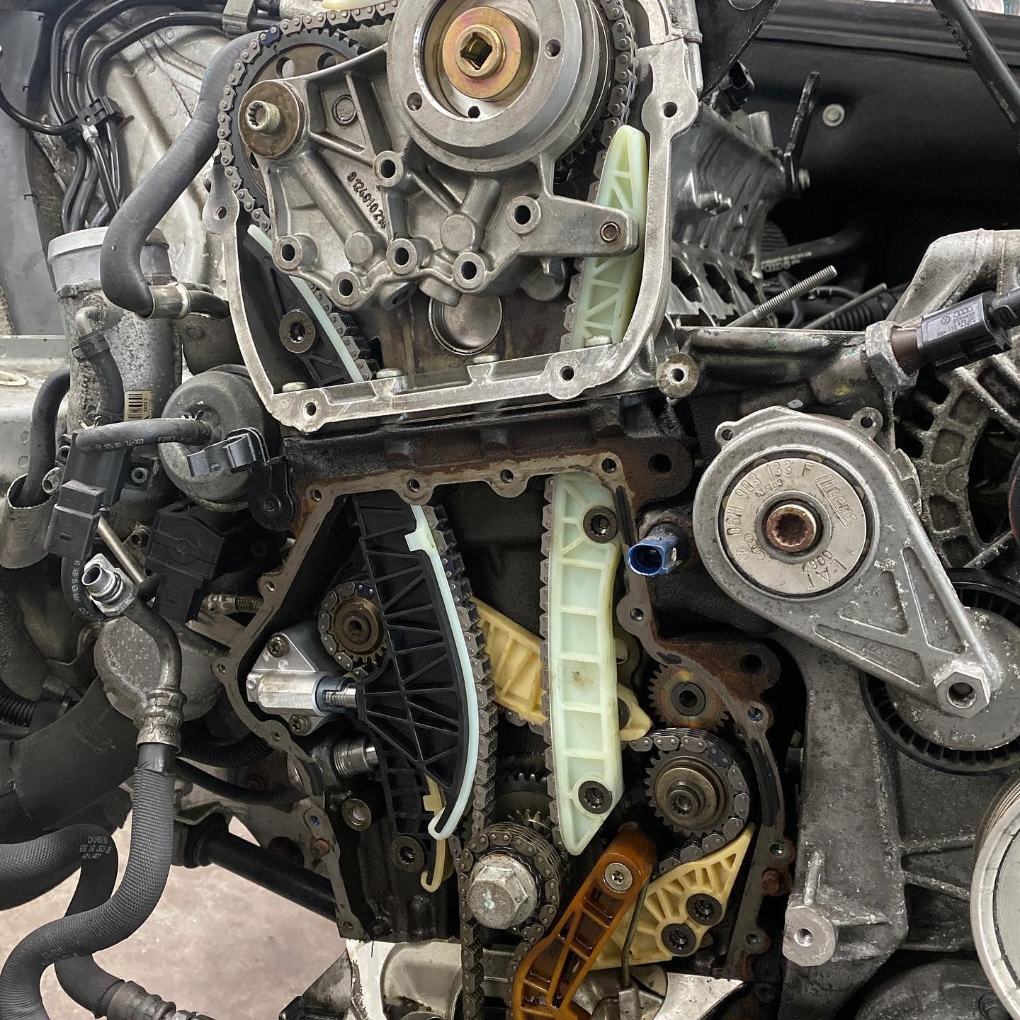 A close up of a car engine with the timing chain removed