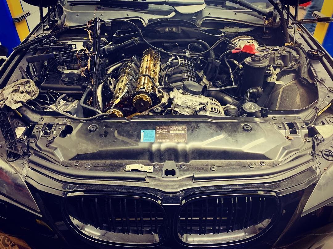 The engine of a bmw is shown with the hood open.