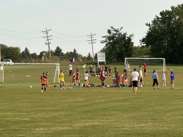 A group of people are playing soccer for Tri-Cities Soccer Association