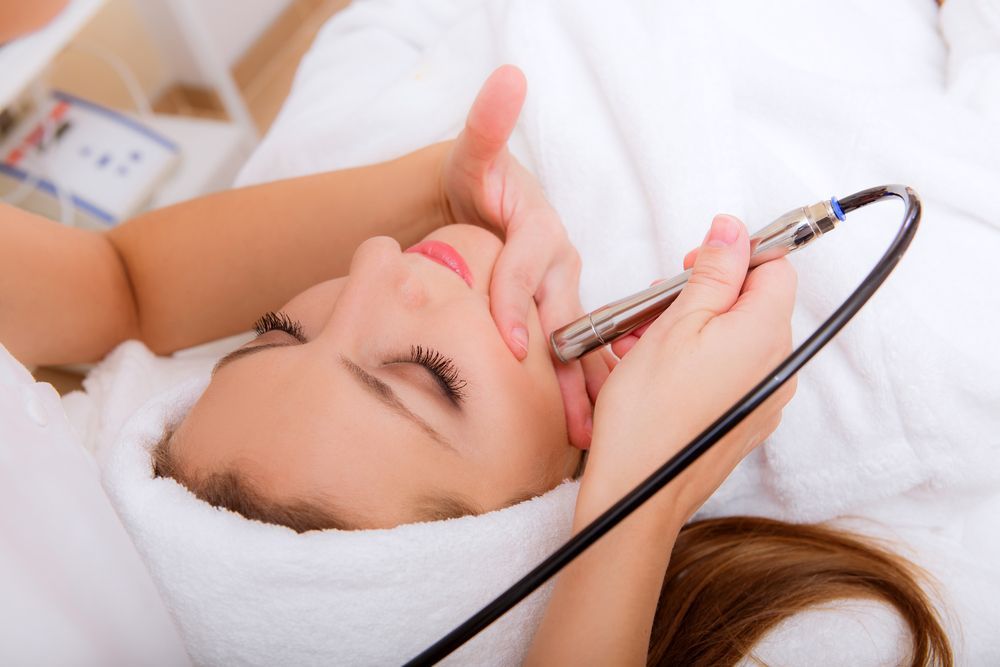 Woman Receiving a Facial Treatment with A Handheld Device — Beauty In Profile In Salamander Bay, NSW