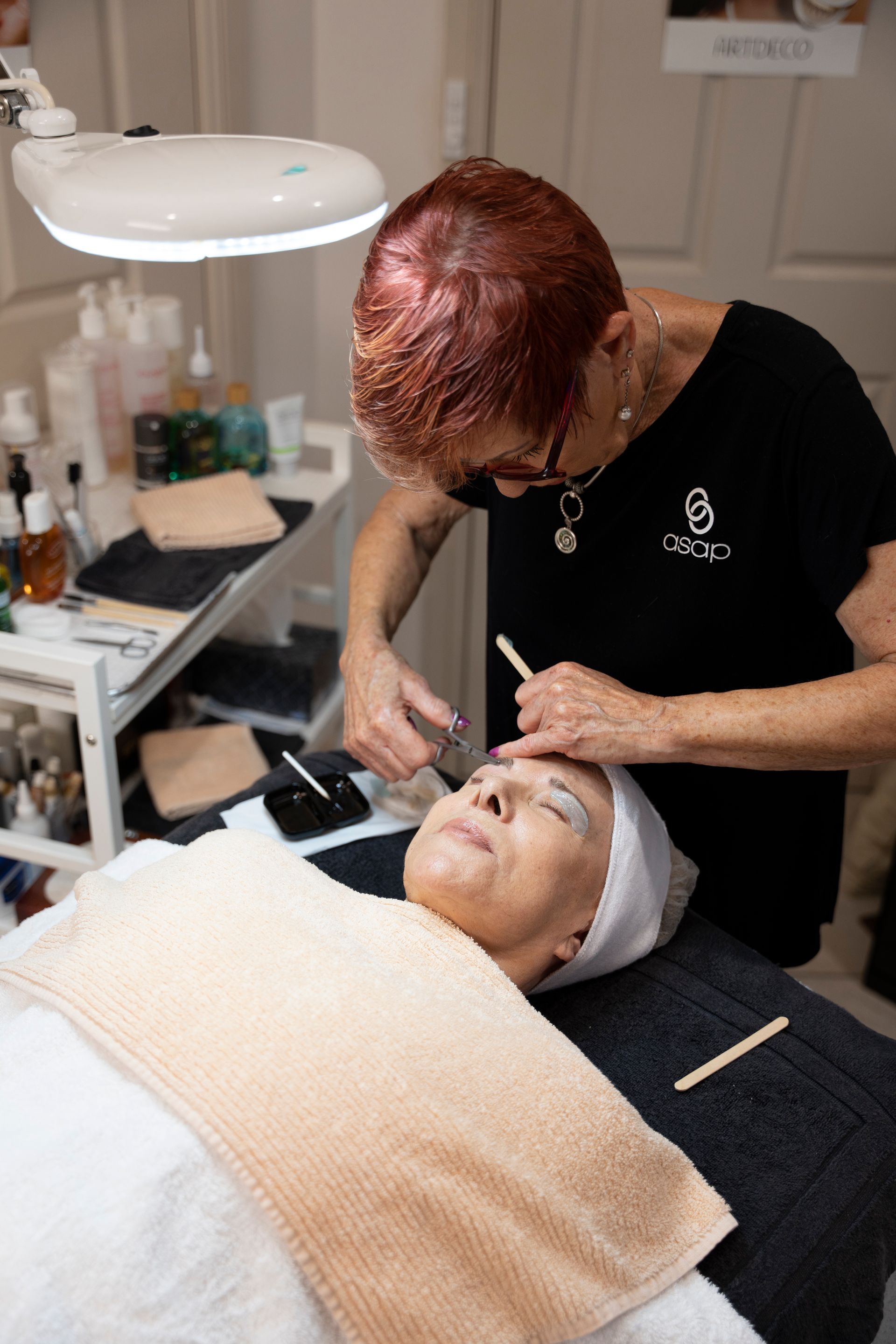 Woman Receiving Eyebrow Treatment in Spa — Beauty In Profile In Salamander Bay, NSW