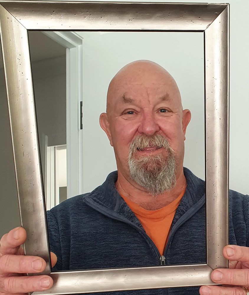 Man Holding a Frame — Picture Framing in Lammermoor, QLD