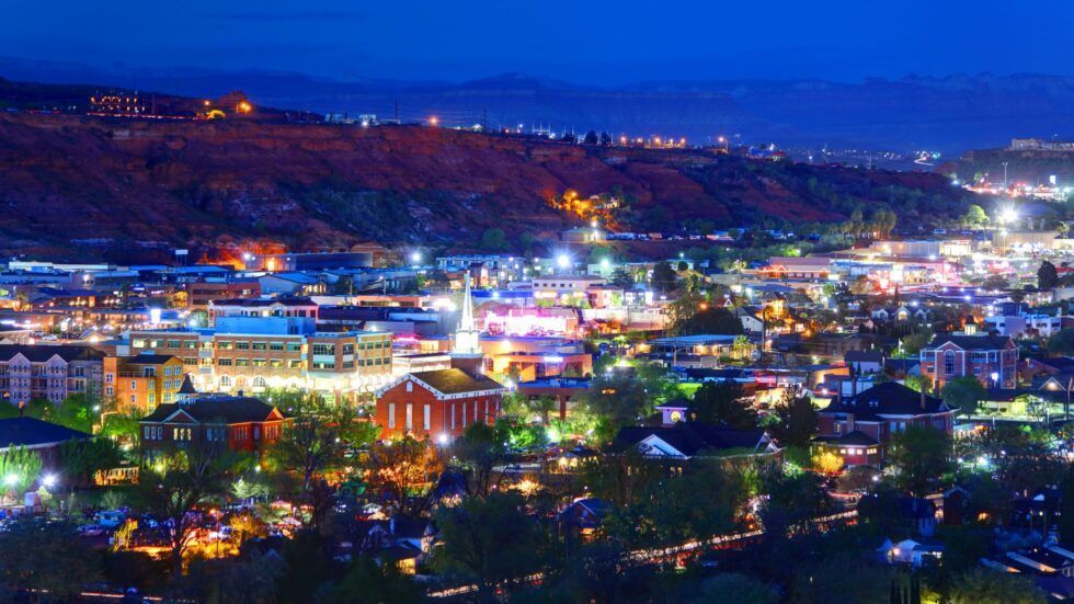 An aerial view of a city, St. George, at night with lots of lights