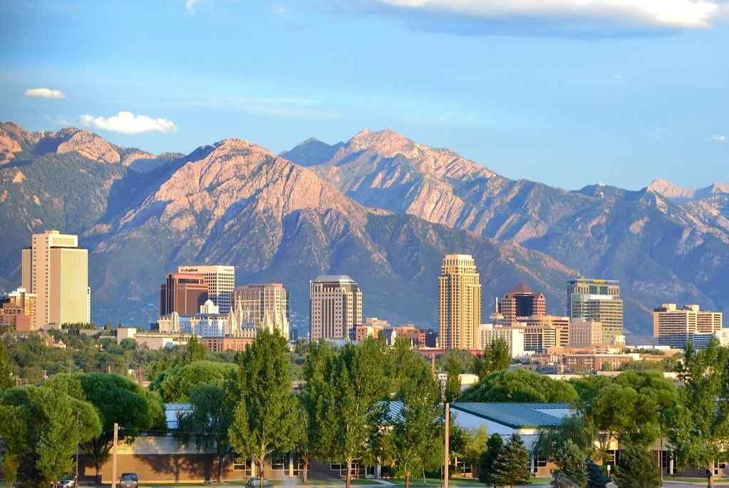 An aerial view of a city with mountains in the background.