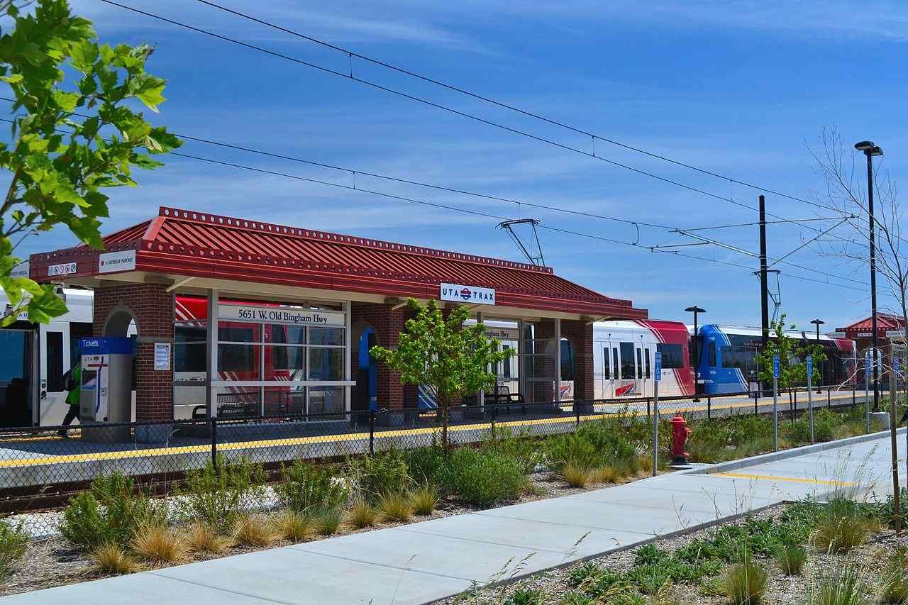 A train station with a fire hydrant in front of it.
