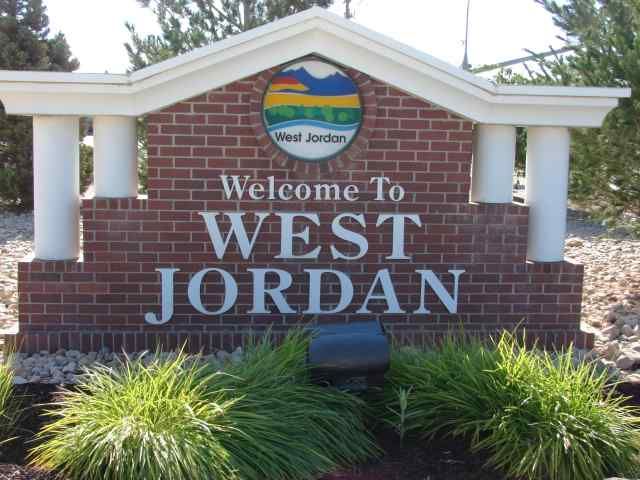 A brick sign that says welcome to west jordan