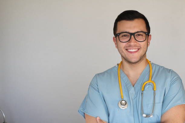 A young man wearing glasses and a stethoscope around his neck is smiling - New City, NY - A & T Certified