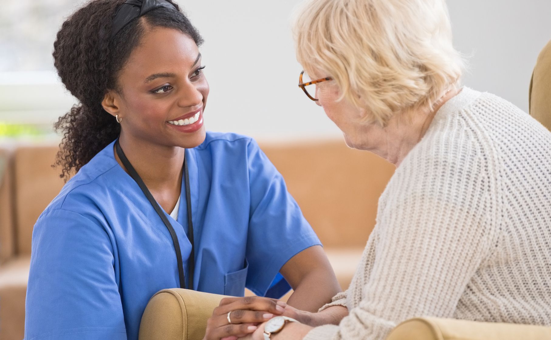 A nurse is holding the hand of an elderly woman - New City, NY - A & T Certified