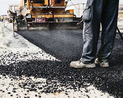 Man's legs on newly laid asphalt — Plainfield, IL — Power Paving