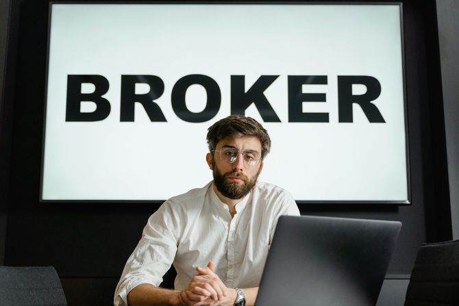 Professional mortgage broker working at a laptop.
