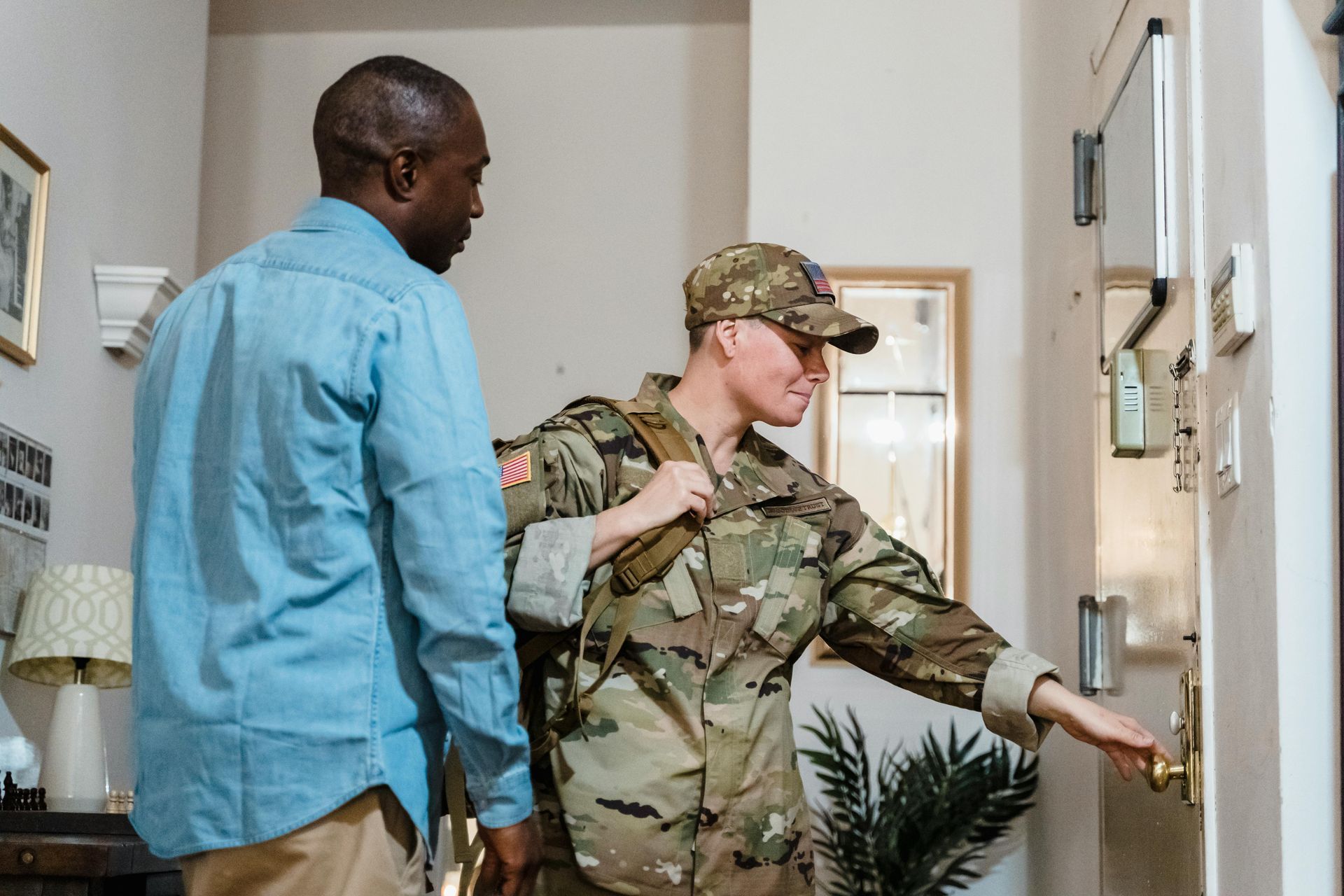 Soldier in uniform entering a home using a VA loan.