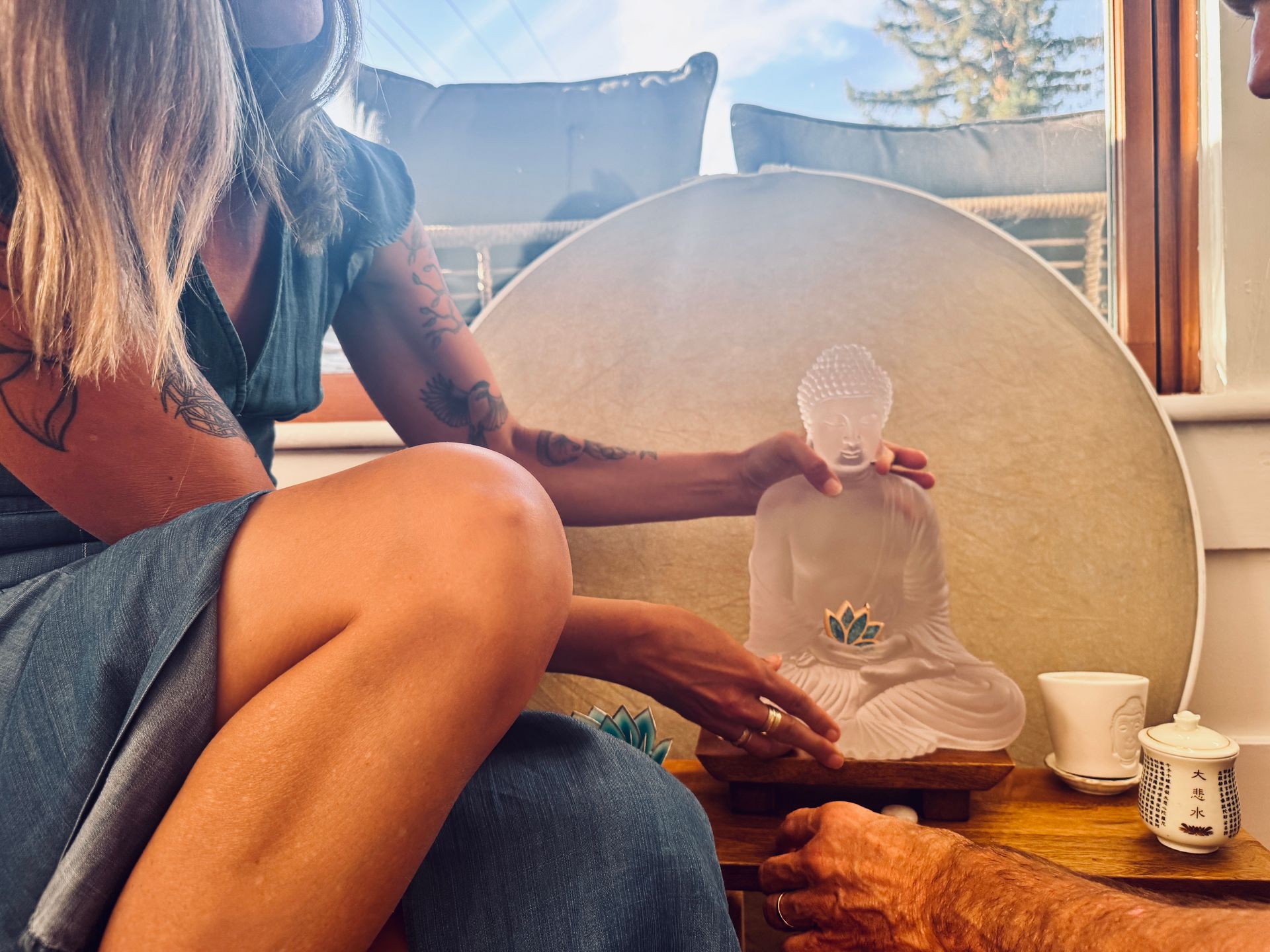 A woman is sitting in a chair talking to another woman.