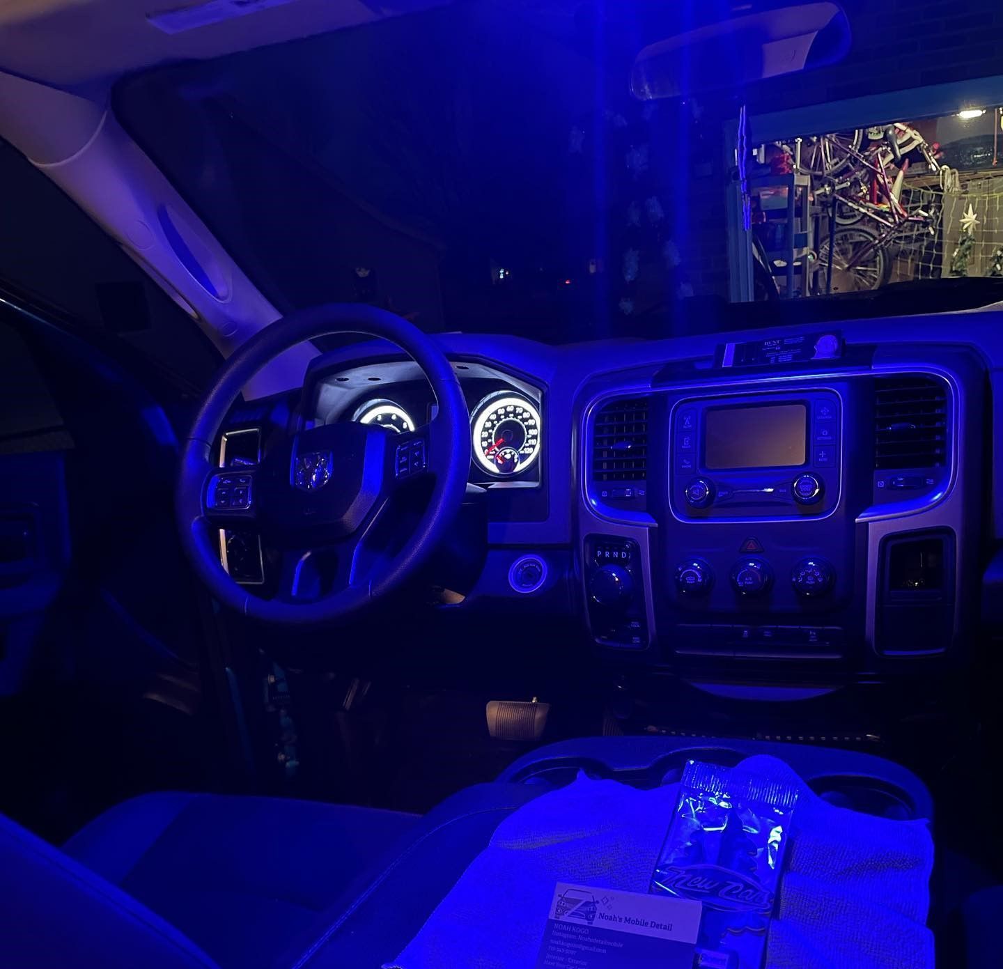 The interior of a car is lit up with blue lights