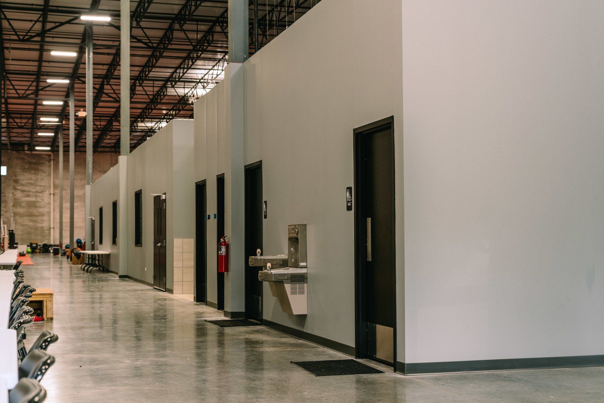 A large warehouse with a lot of doors and a water fountain.