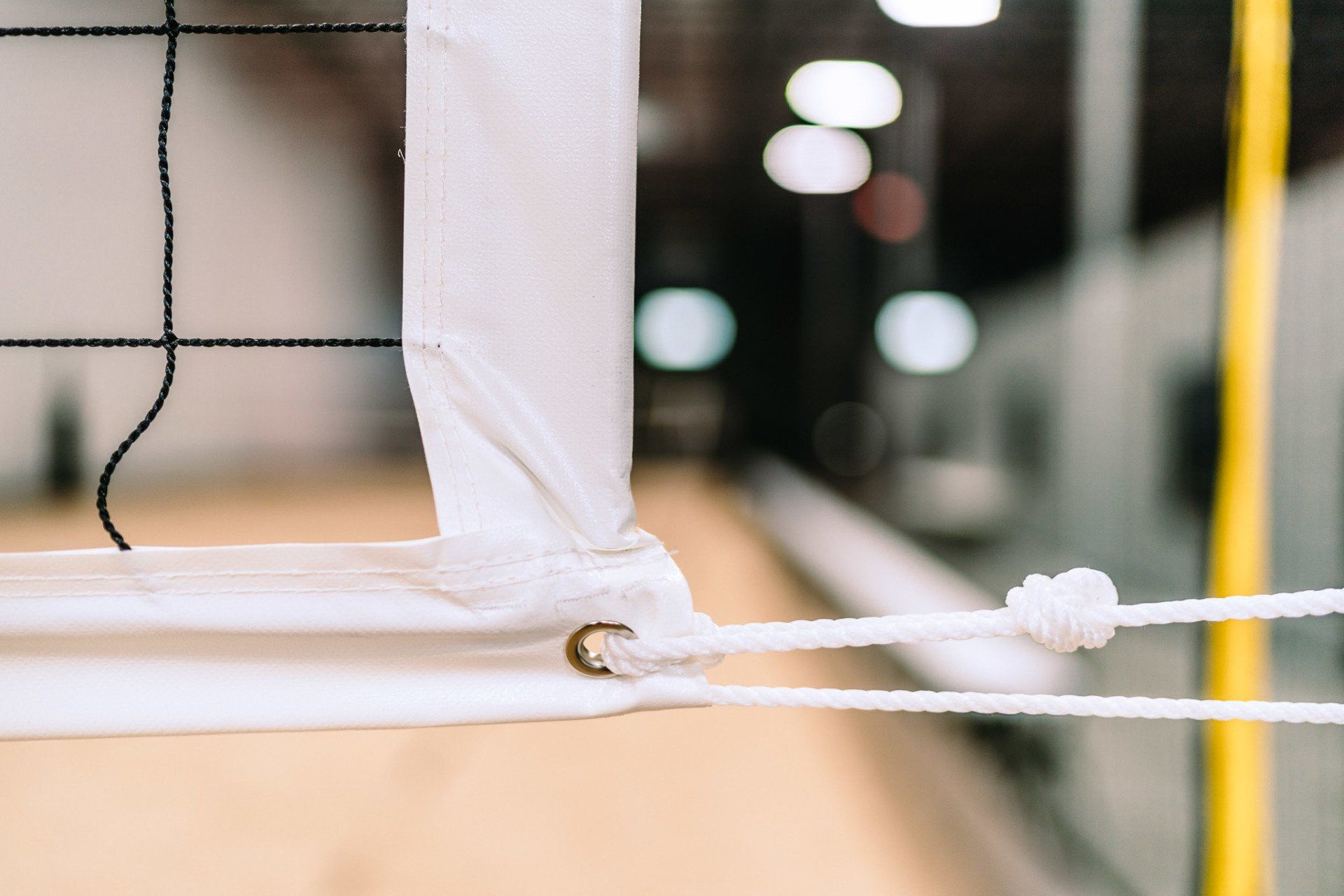 A close up of a volleyball net in a gym.