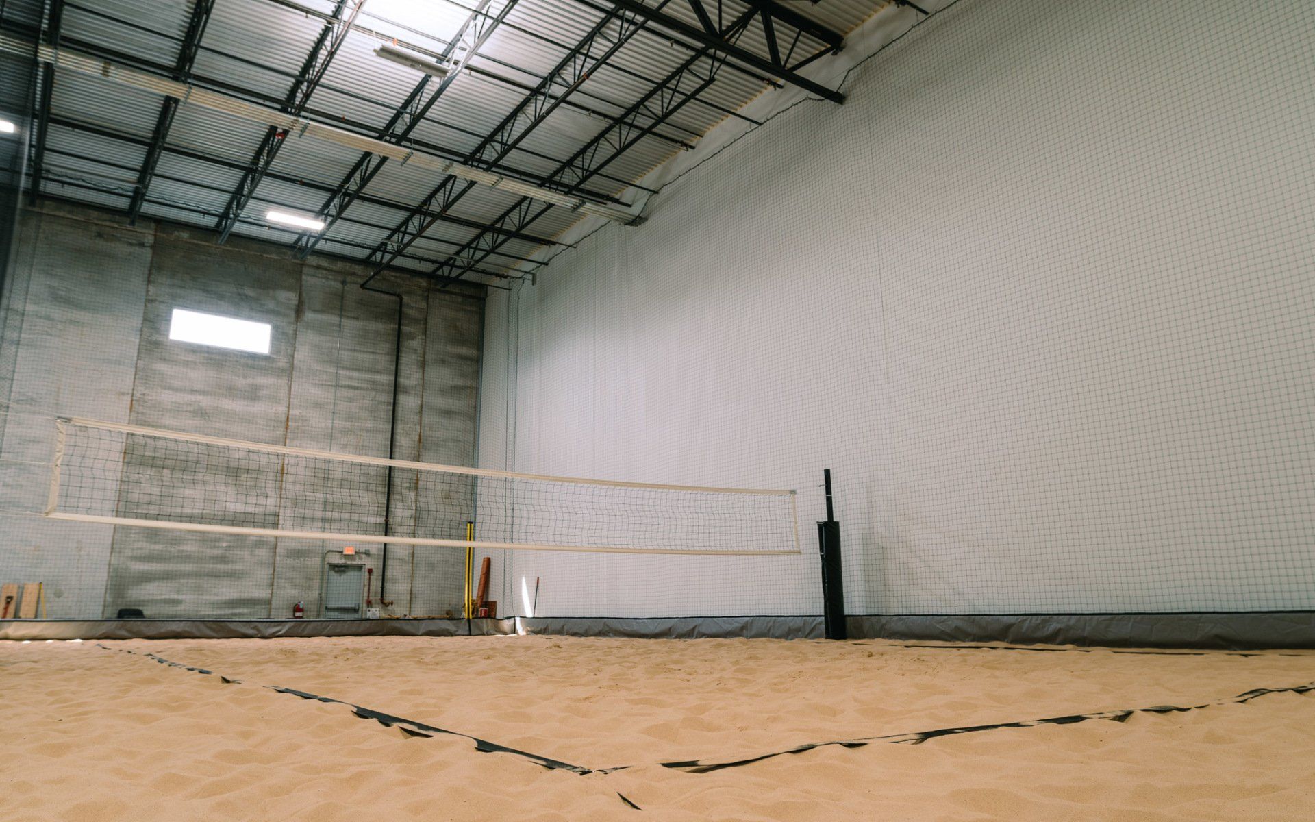 There is a volleyball net in the middle of the room.