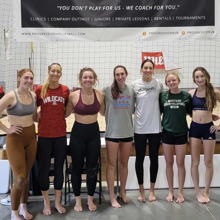 A group of women are posing for a picture in front of a sign that says you do n't play for us