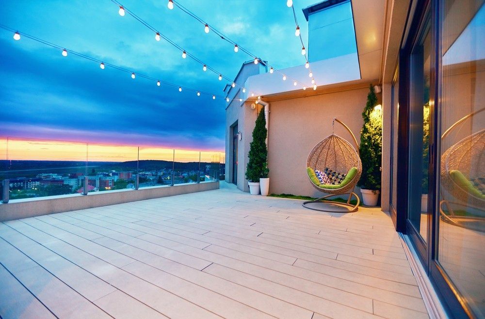 A Balcony With a Chair and a View of the City at Sunset — JPR Concepts in Burleigh Heads, QLD