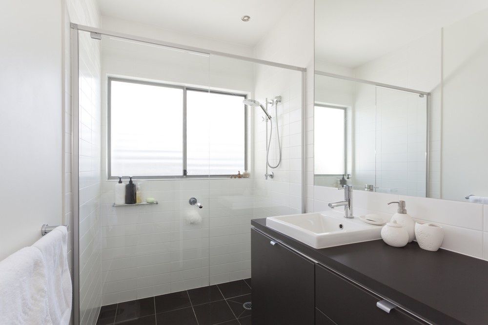 A Bathroom With a Sink , Shower , Mirror and Window — JPR Concepts in Burleigh Heads, QLD