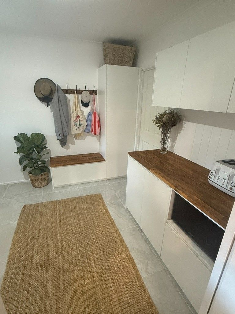 A Kitchen With White Cabinets and a Wooden Counter Top — JPR Concepts in Burleigh Heads, QLD