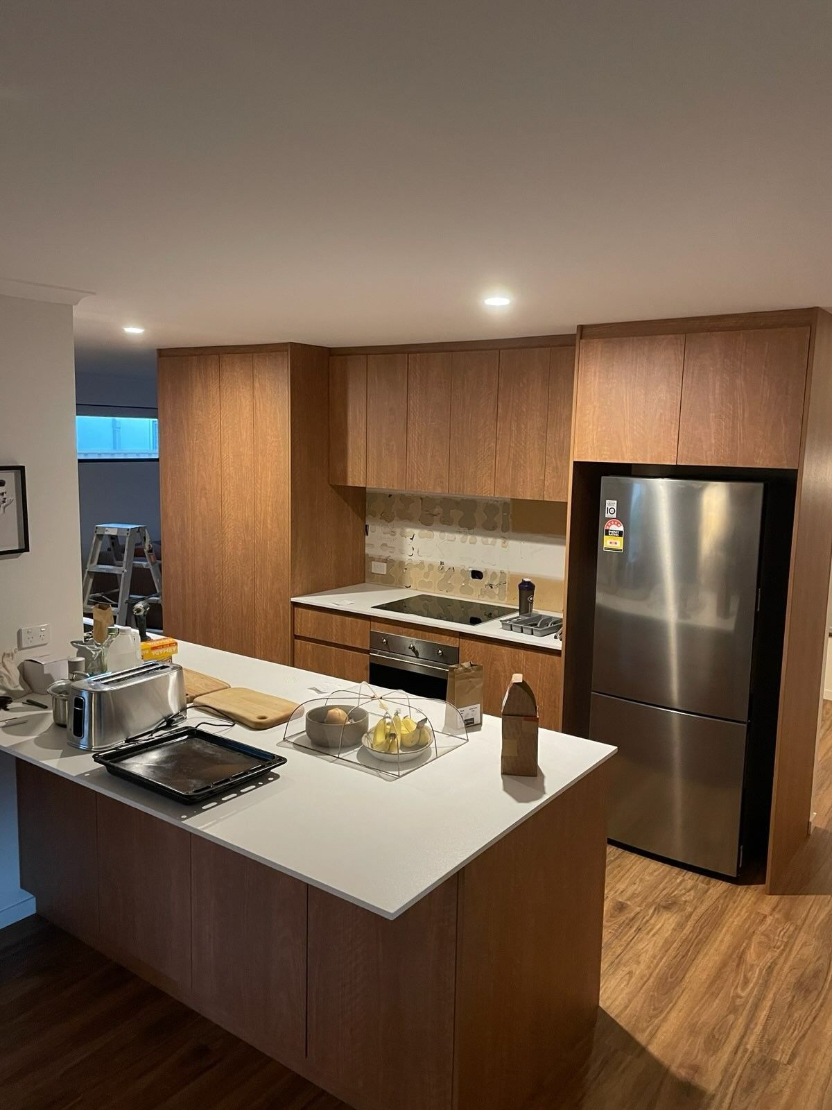 A Kitchen With Stainless Steel Appliances and Wooden Cabinets — JPR Concepts in Burleigh Heads, QLD
