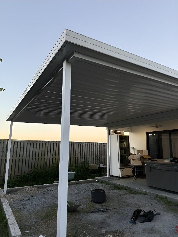 A White Awning is Sitting on Top of a Patio Next to a Fence — JPR Concepts in Burleigh Heads, QLD