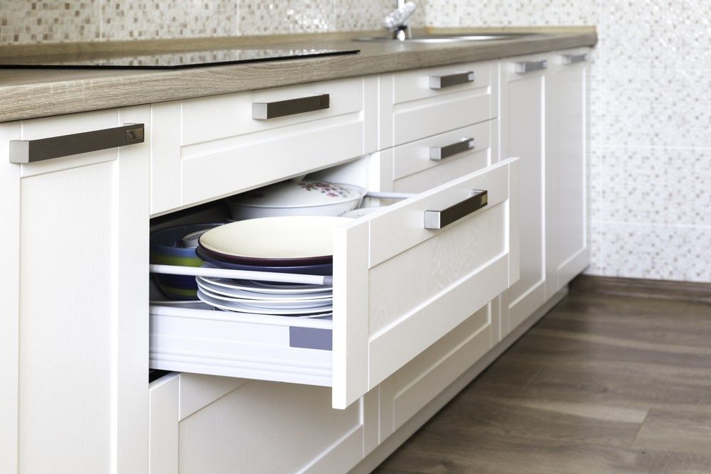 A Kitchen With White Cabinets and a Drawer Filled With Plates — JPR Concepts in Burleigh Heads, QLD