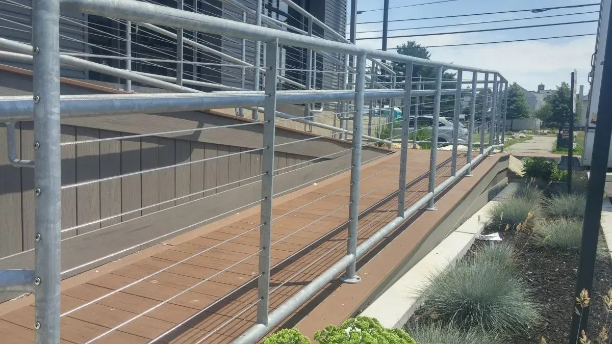 A fence with a railing on the side of a building.