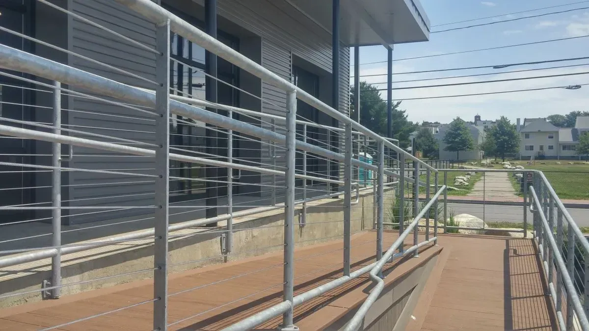 A staircase with a metal railing leading up to a building.