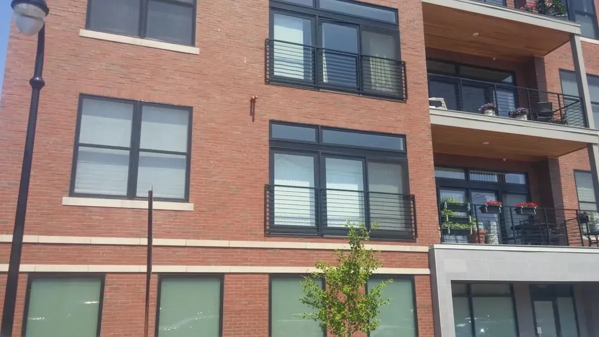 A large brick building with a lot of windows and balconies.