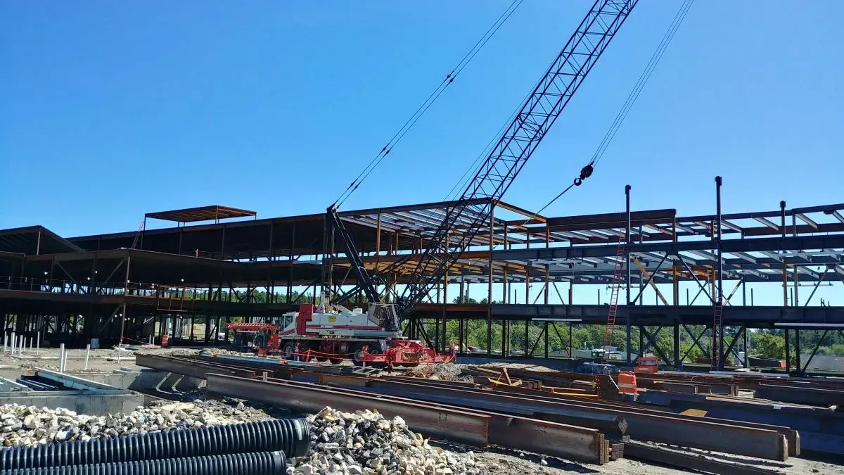 A large building under construction with a crane in the background.
