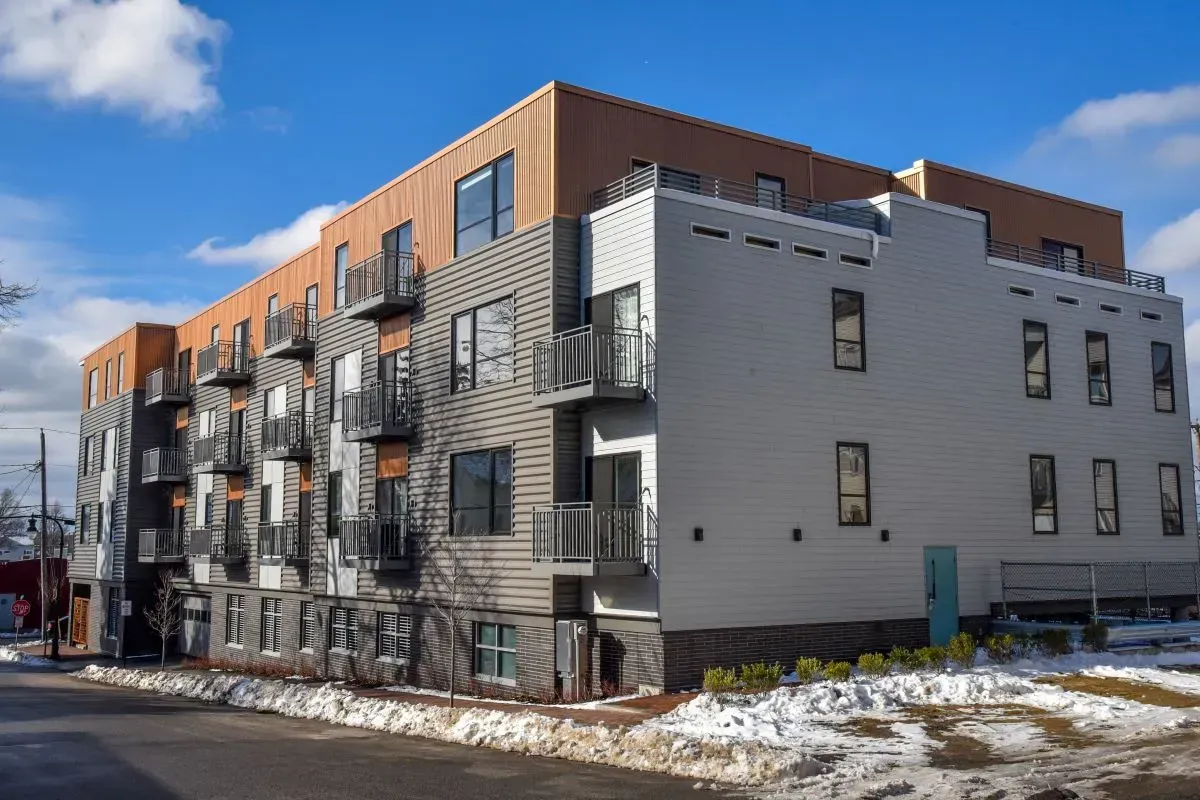 A large apartment building with a lot of windows and balconies.