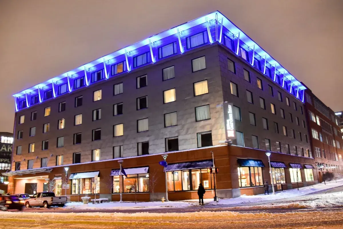 A large building with a lot of windows is lit up at night.