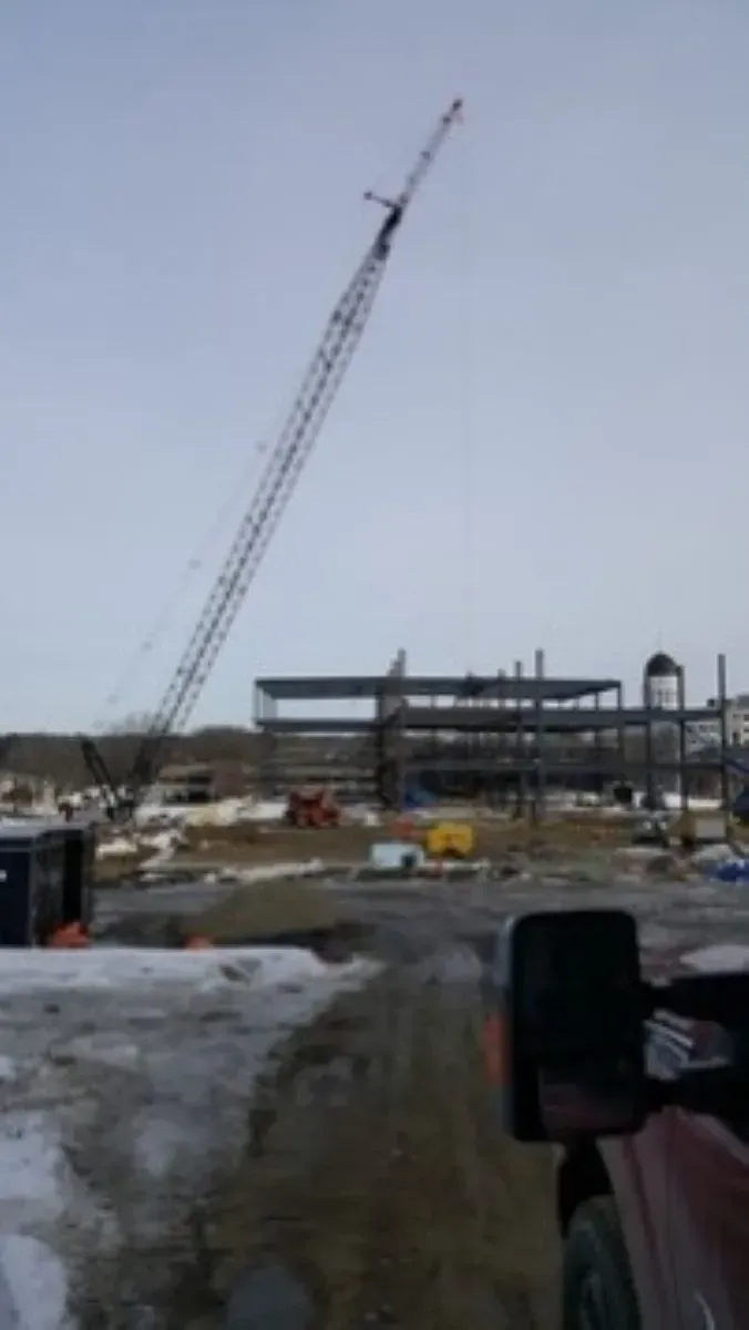 A construction site with a large crane in the background