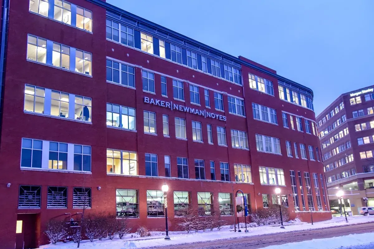 A large red building with a lot of windows is lit up at night
