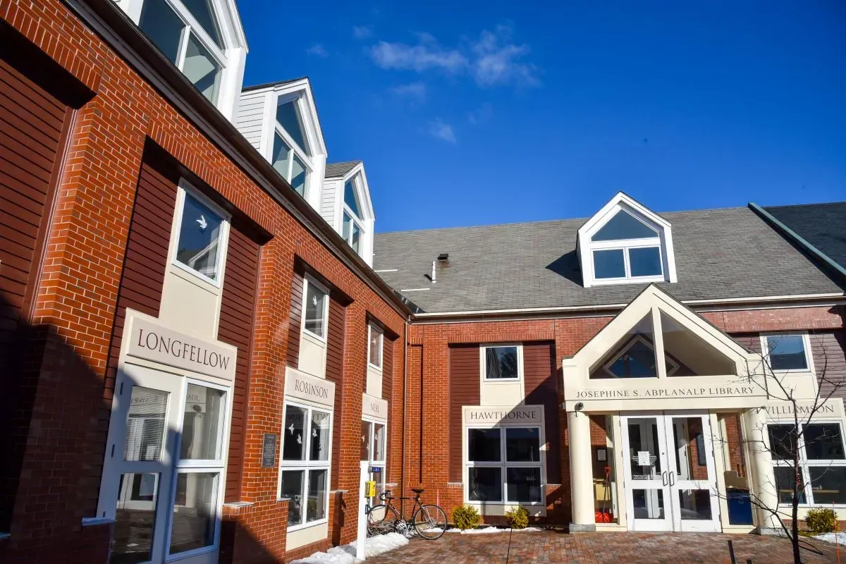 A large brick building with a blue sky in the background