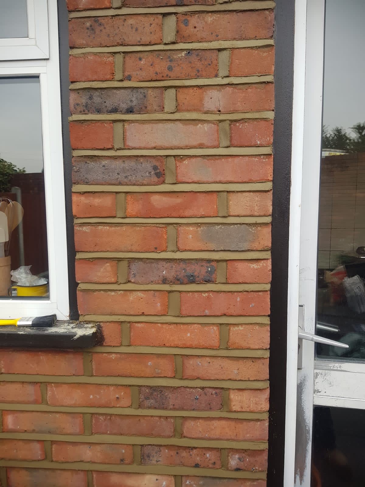 brick wall with window and door