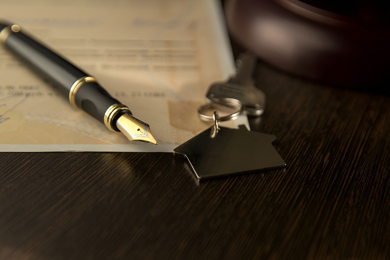 Pen And Keys With House Key Tag On Legal Document