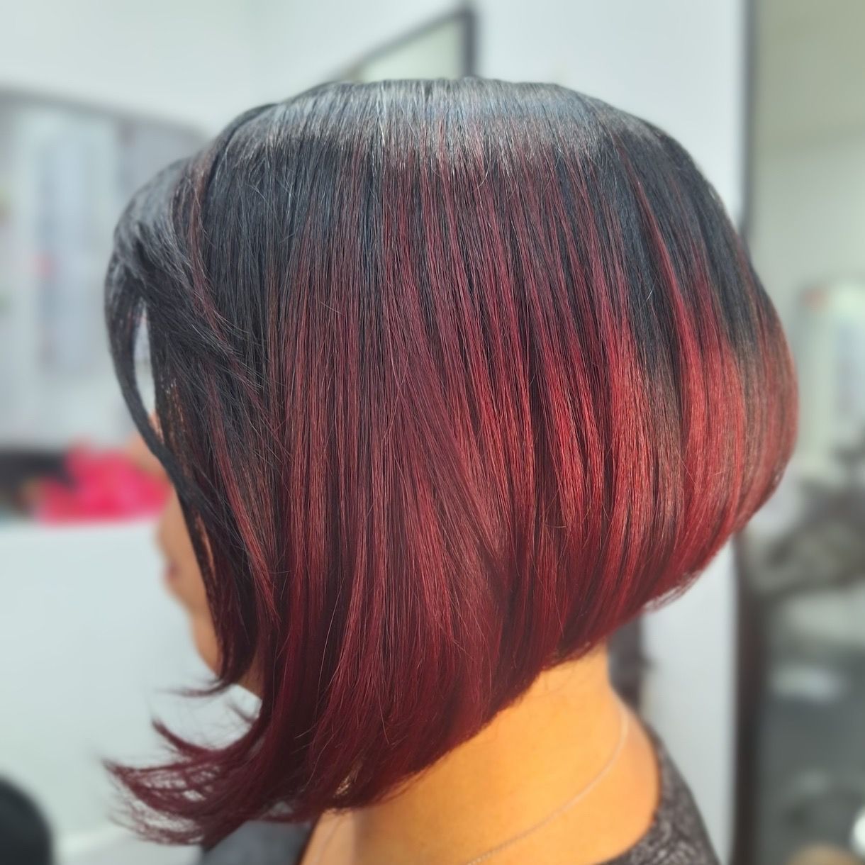 bob hair cut with red and black gair done at hair salon