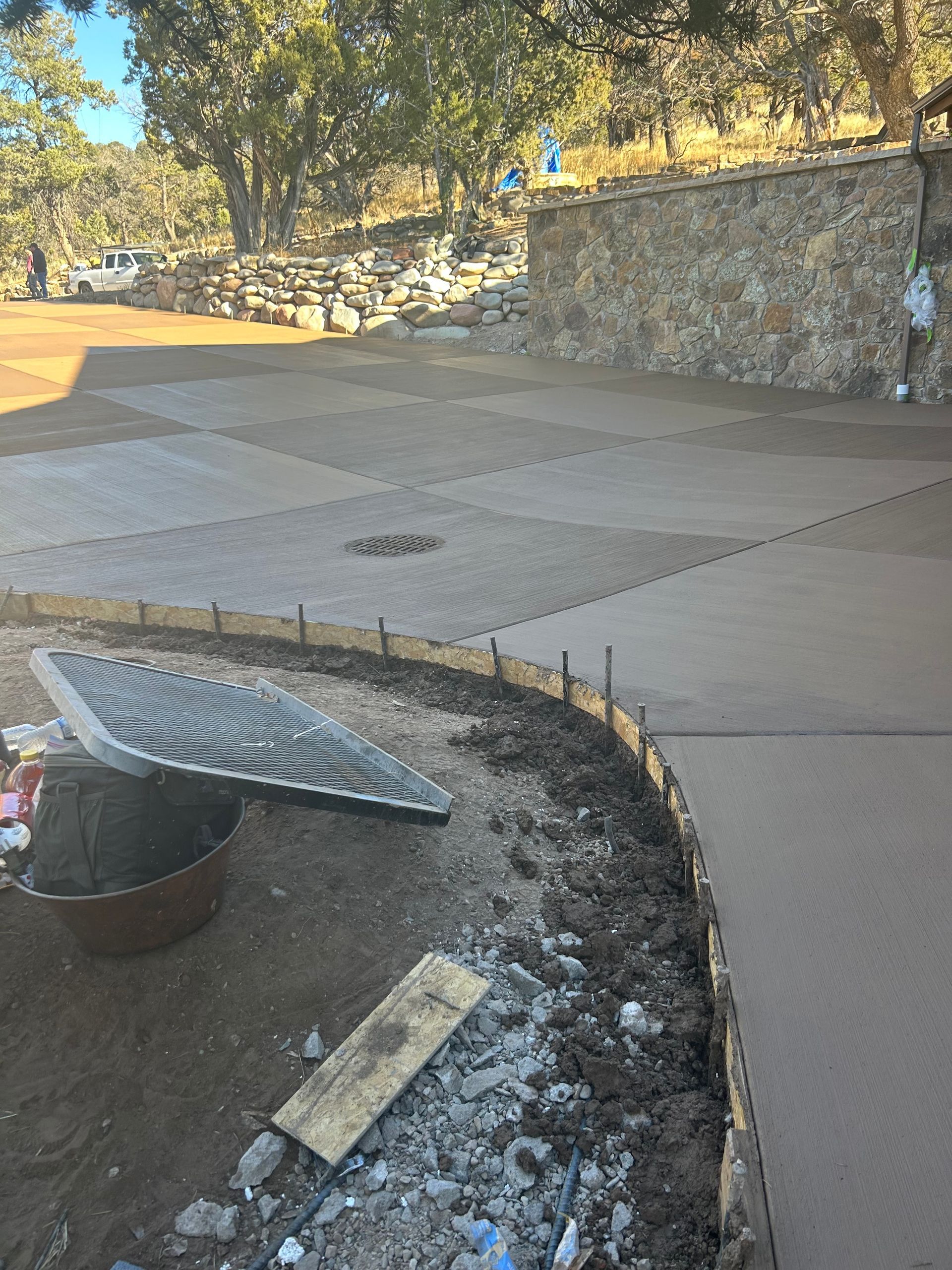 Light gray house with a two-car garage and small front porch on a sunny day.