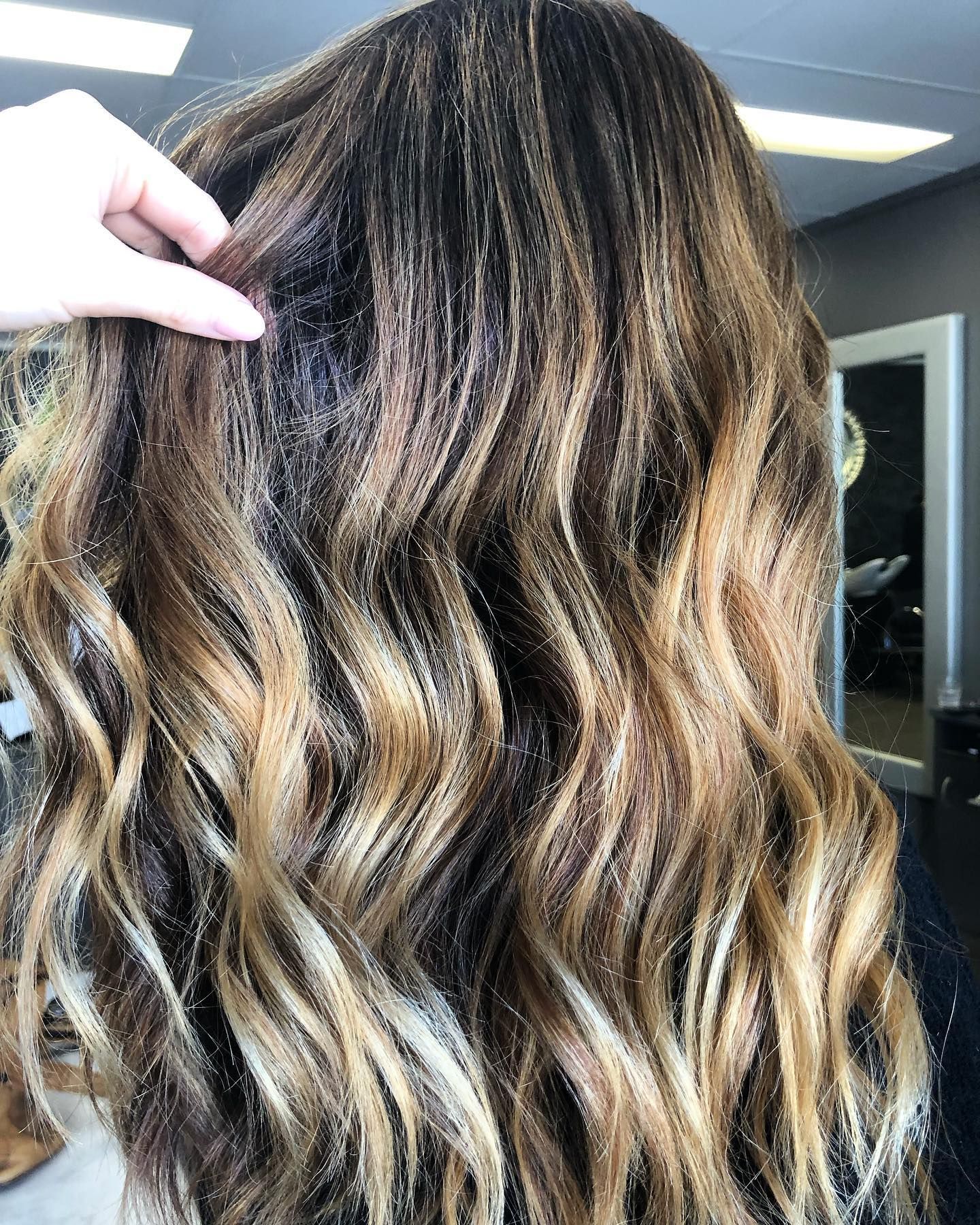 Woman's Wavy Hair in Various Shades of Brown and Blonde — Salon South in Mount Sheridan, QLD