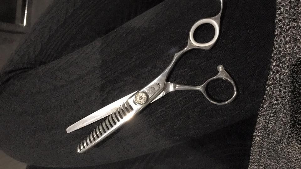 Hair Thinning Shears on Dark Fabric — Salon South in Mount Sheridan, QLD