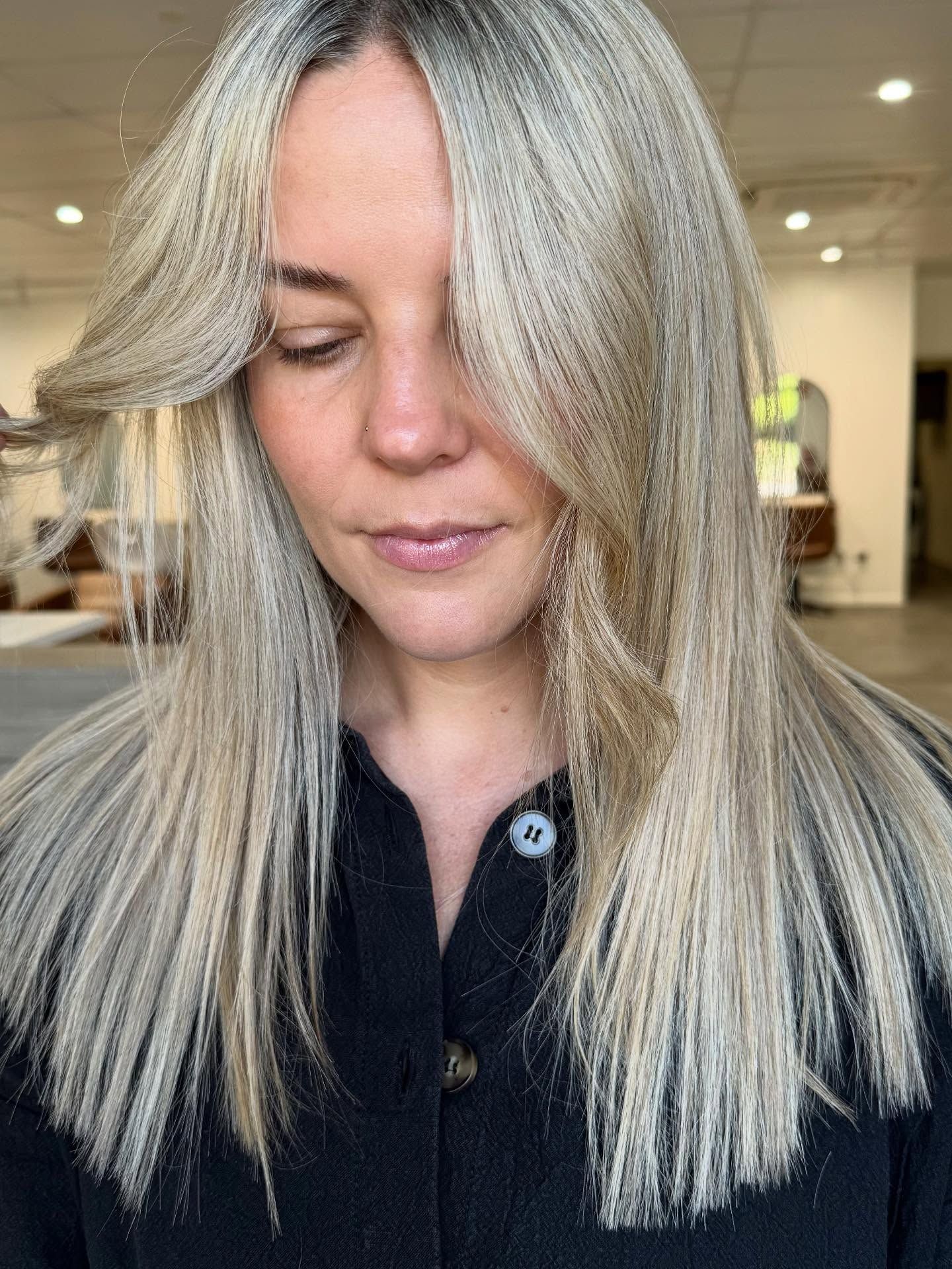 Woman With Long, Blonde Hair Styled With a Side-swept Bang — Salon South in Mount Sheridan, QLD