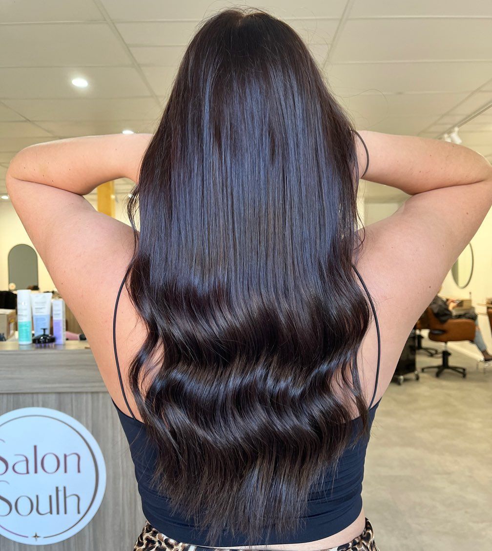 Woman With Long, Shiny, Dark Brown Wavy Hair — Salon South in Mount Sheridan, QLD