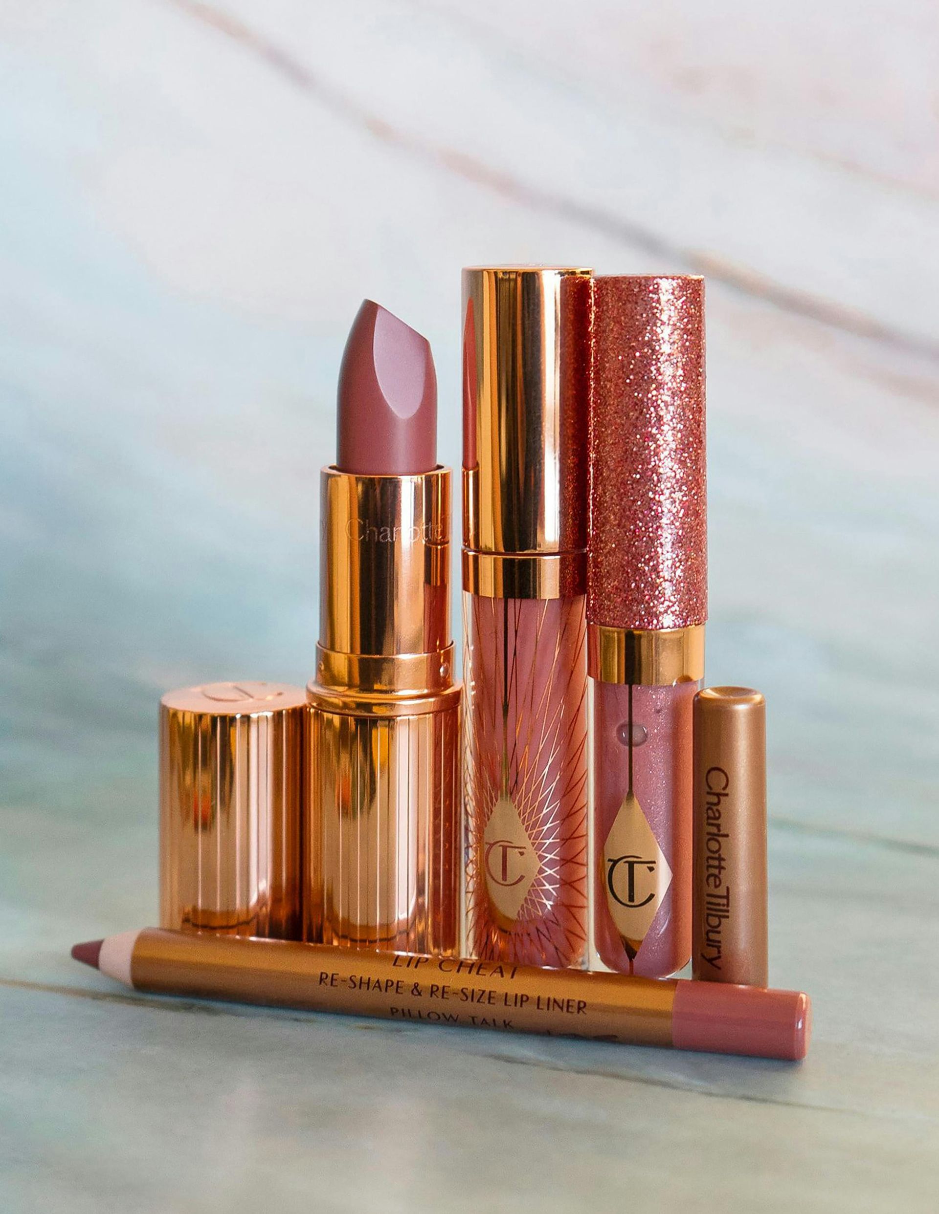 Woman With Updo Hairstyle and Floral Robe Looking Down, Sitting on a Chair — Salon South in Mount Sheridan, QLD